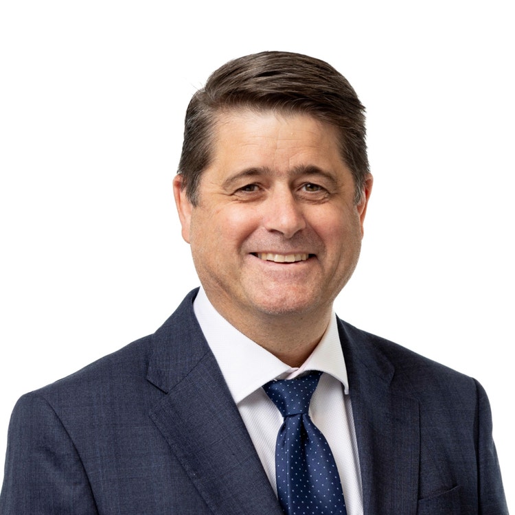 man wearing suit and tie smiling in profile photo