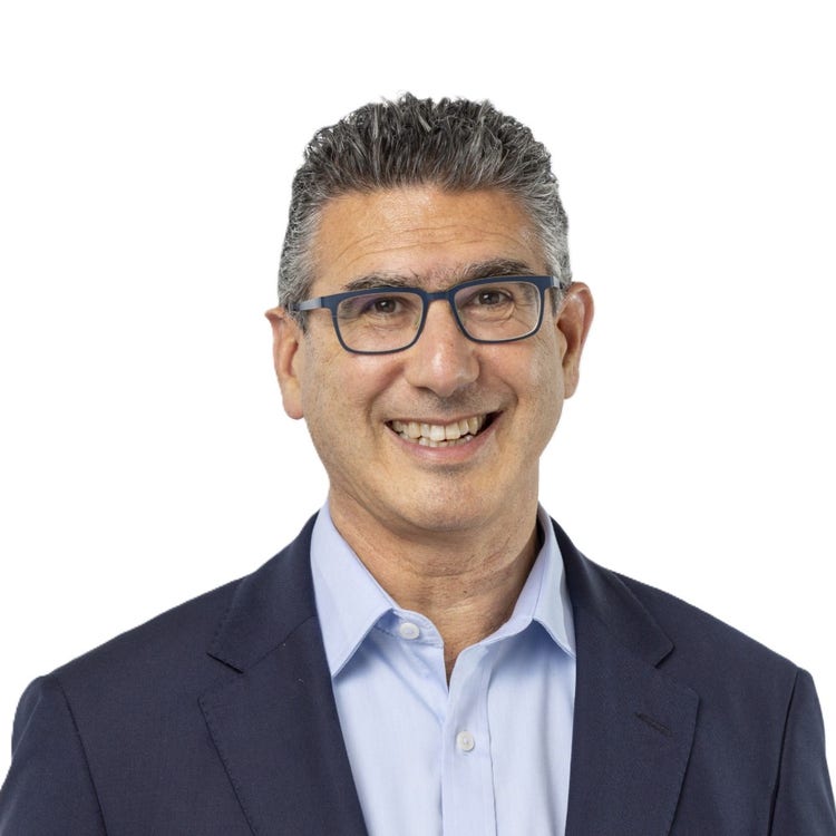 man wearing suit and tie smiling in profile photo