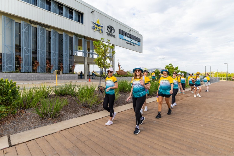 people walking in spirit to cure shirts outside building