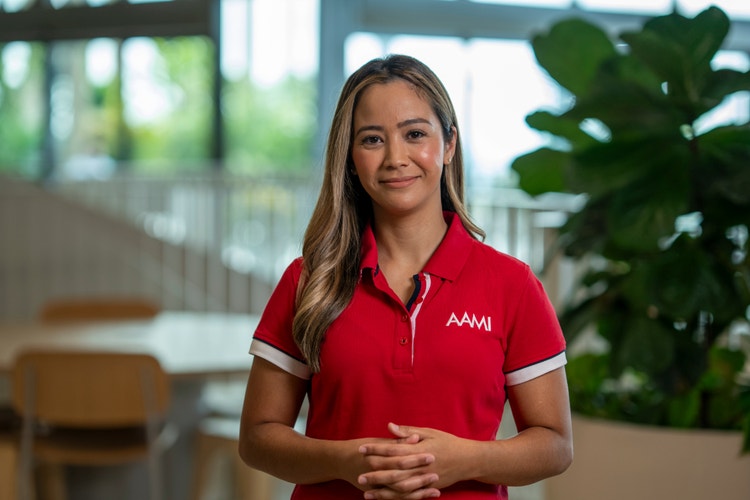 woman wearing red AAMI shirt in office