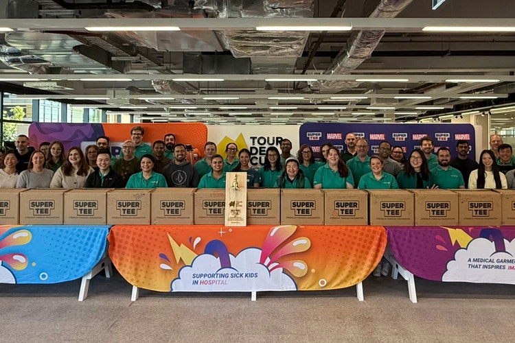 group of people in front of super tee boxes