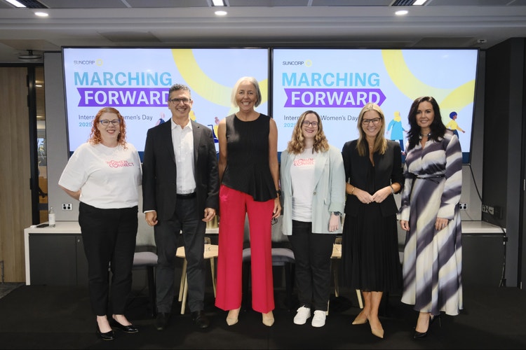 group photo of women&#39;s connect group in front of screens with marching forward logo
