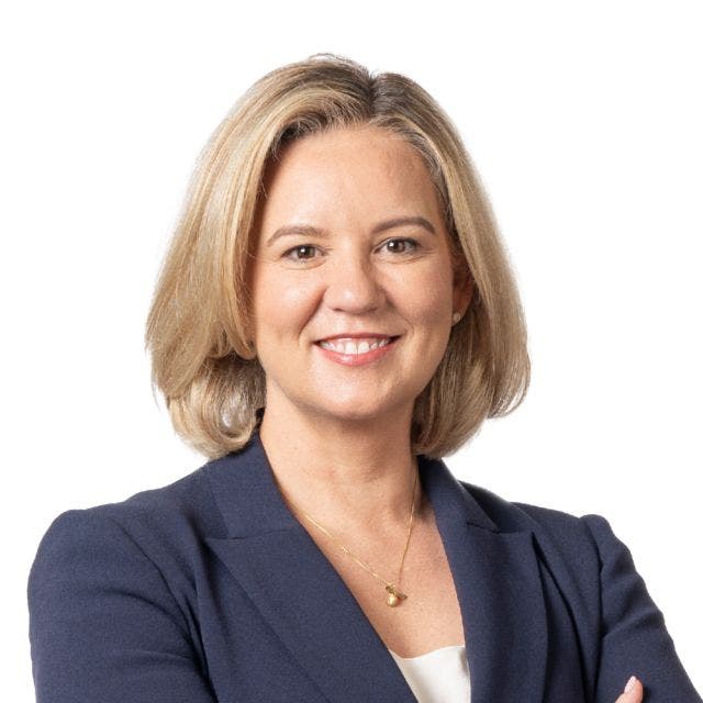 blond woman smiling wearing grey blazer headshot