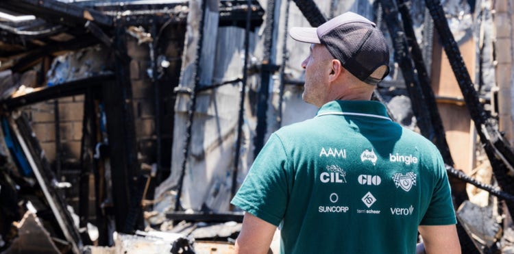 Suncorp assessor looking at a burnt house
